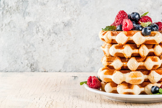 a stack of waffles with berries on top